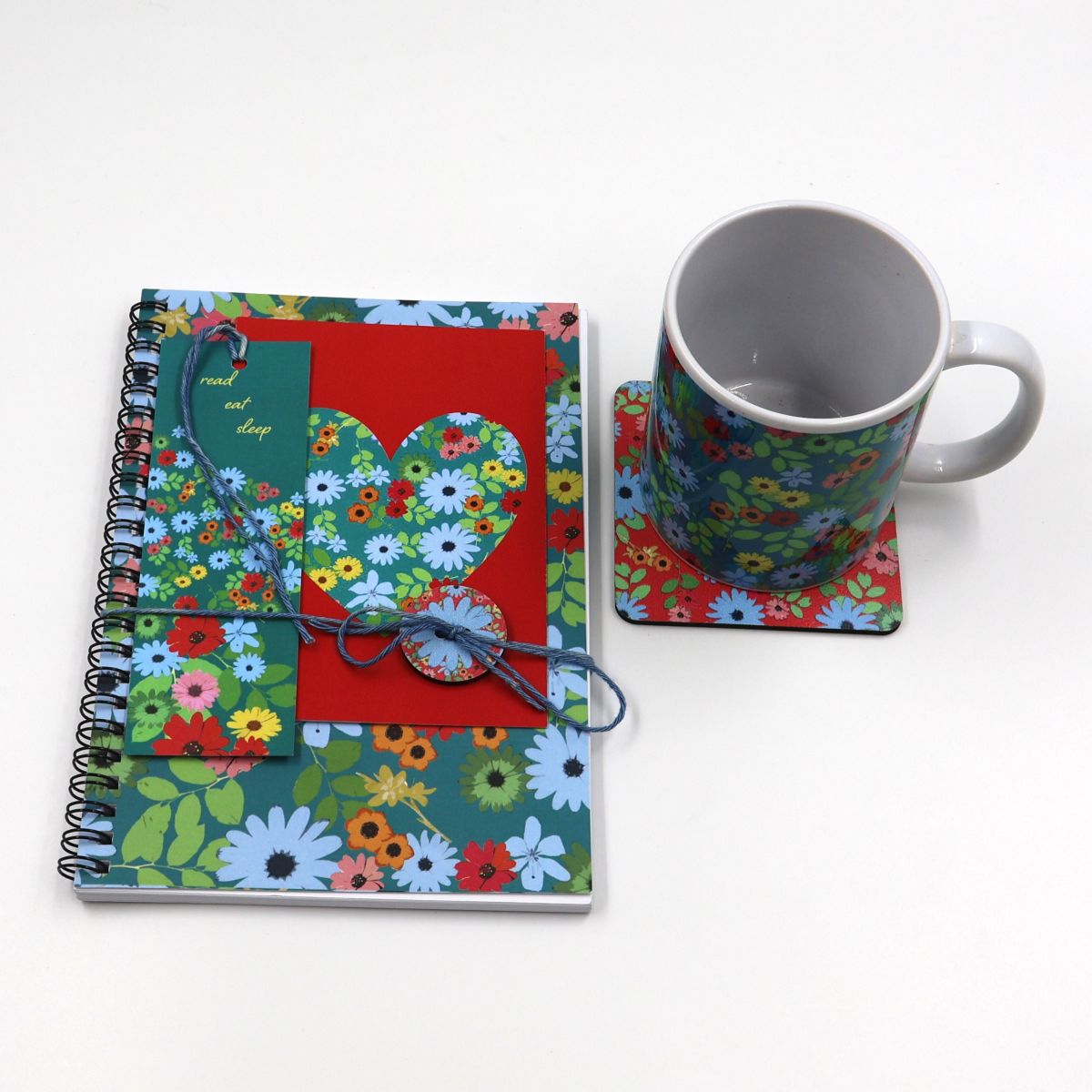 Handmade South African nature gift box neatly arranged with an A5 wildflower journal a ceramic coffee mug matching desk coaster paper bookmark and a coordinated greeting card