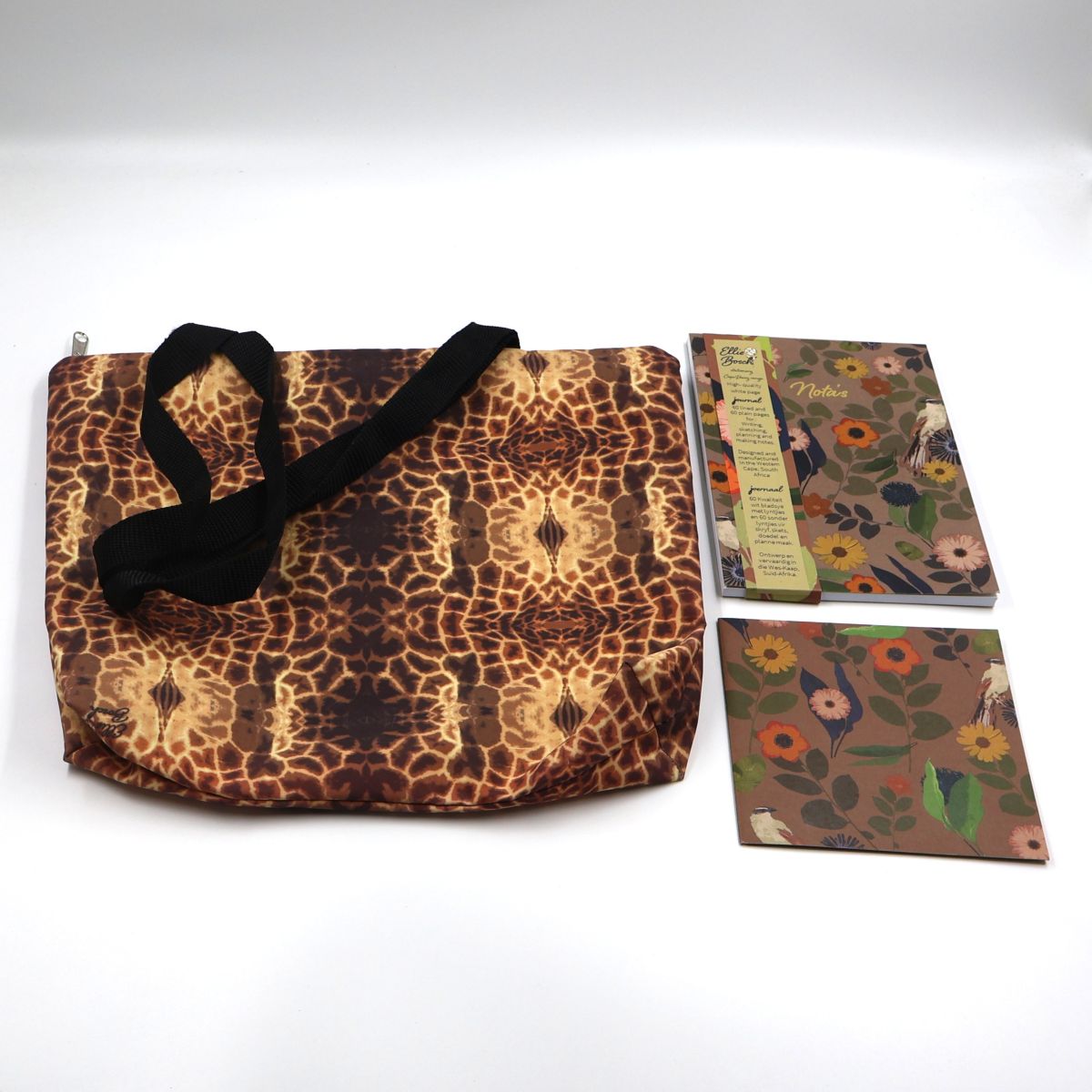 Individual wildlife stationery and travel items shown separately flat lay style including a split page lined and blank A5 notebook and a zippered waterproof canvas shopper bag