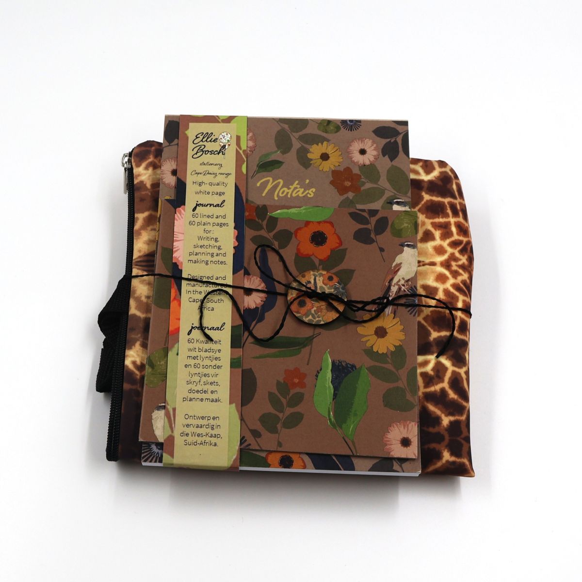 Handmade South African nature gift box neatly arranged with an A5 wild daisy daily journal and a medium zipped waterproof canvas tote bag featuring a brown giraffe pattern
