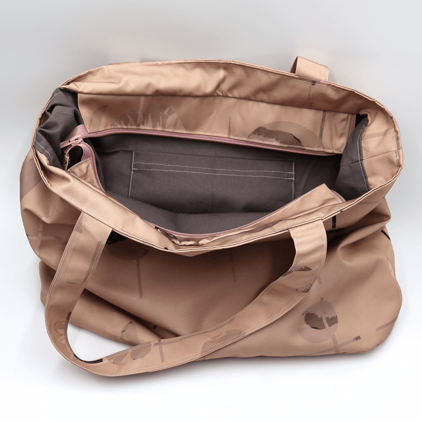 Shoulder bag with geometric/floral design in rusty orange and brown. Perfect for carrying books and documents. Inside view.