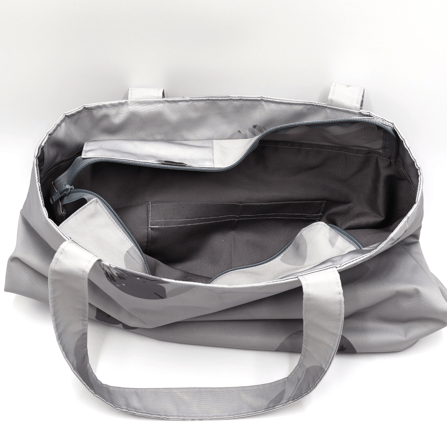 Shoulder bag with daisy floral design in dark and light grey. Perfect for carrying books and documents. Inside view.