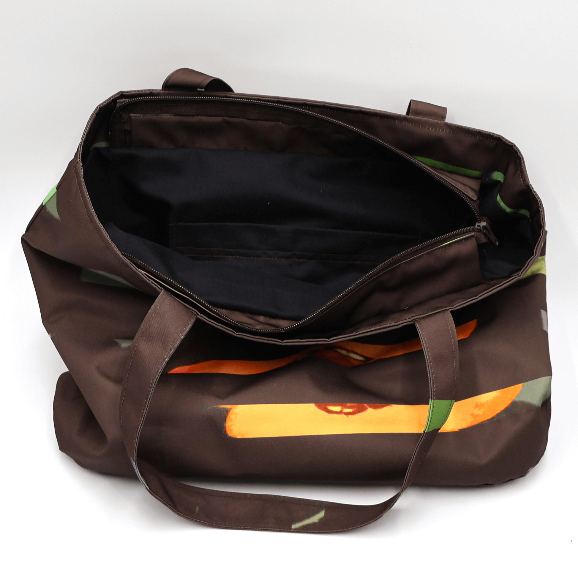 Shoulder bag with bright stripe/floral daisy design on a black background. Perfect for carrying books and documents. Inside view.