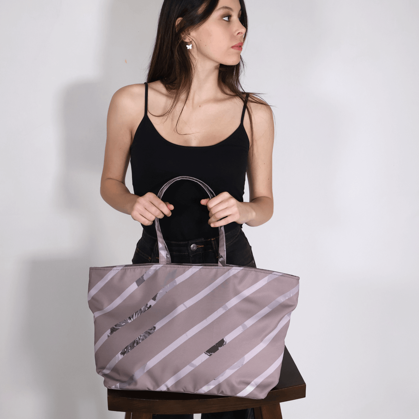 Young woman with the big, sturdy Ellie B shoulder tote bag in dusky plum, burgundy, and grey colors for work and travel.