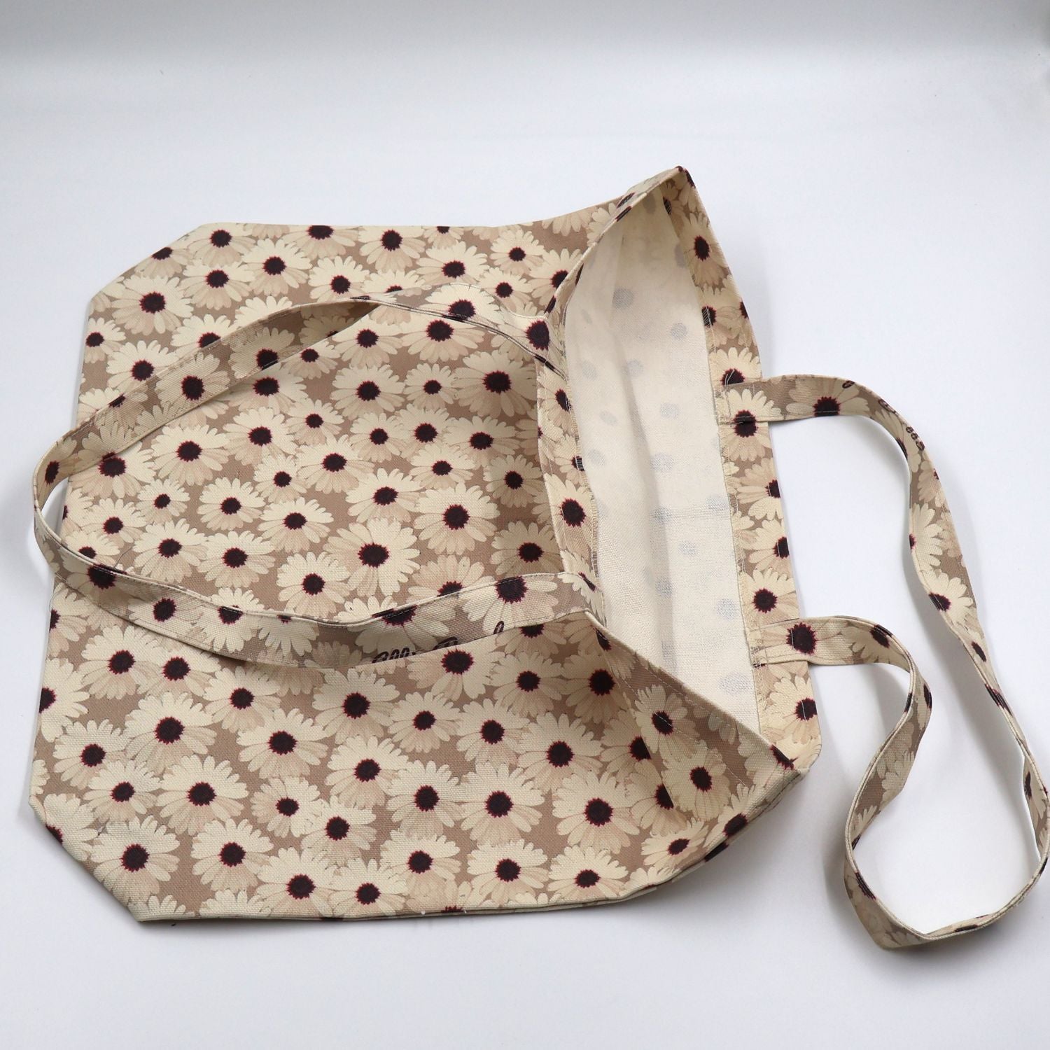 Flat lay view of the handmade ladies mushroom beige canvas tote bag, showcasing the reinforced quality stitching, durable fabric finish, and flat-pack layout.