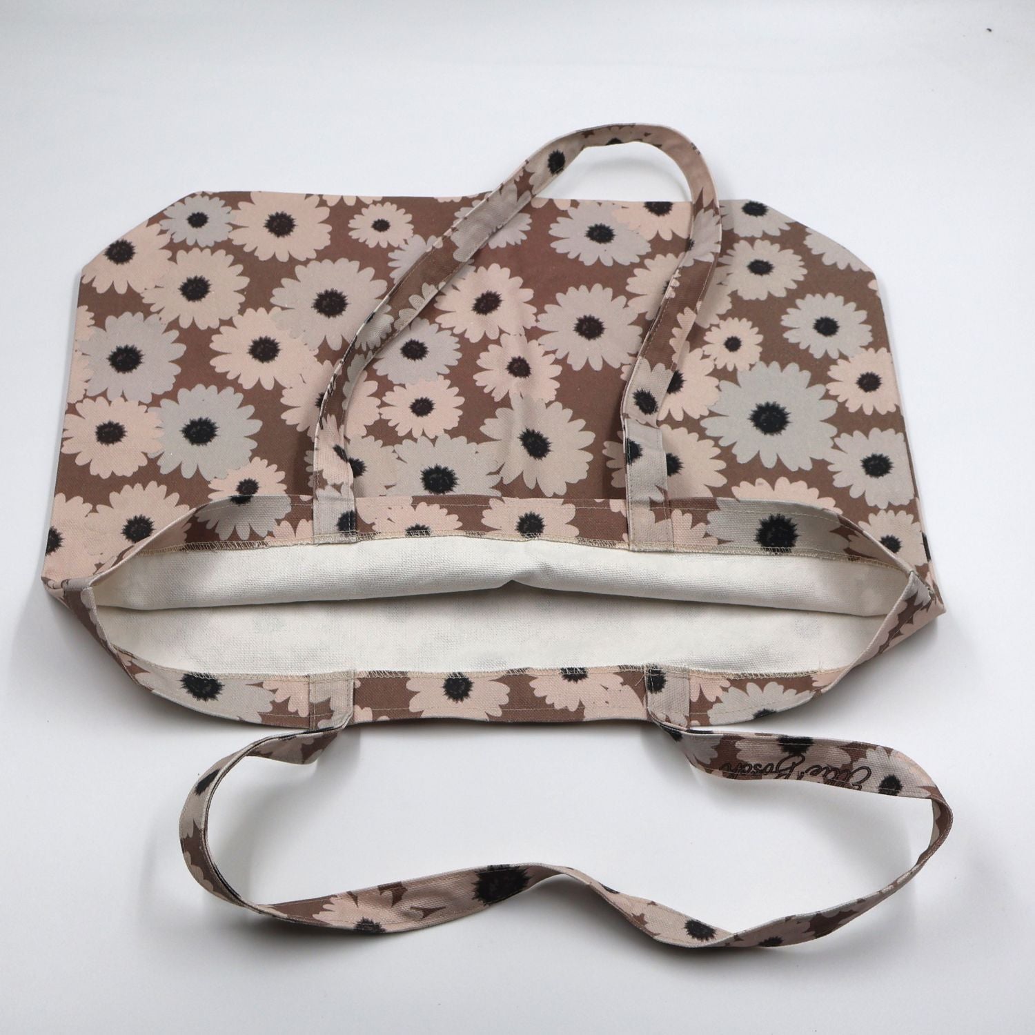 Flat lay view of the handmade ladies sandstone brown canvas tote bag, showcasing the reinforced quality stitching, durable fabric finish, and flat-pack layout.