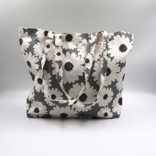 Close-up detail of the bold white wildflower print on the front panel of the ladies sea mist grey canvas tote bag, highlighting the premium fabric texture.