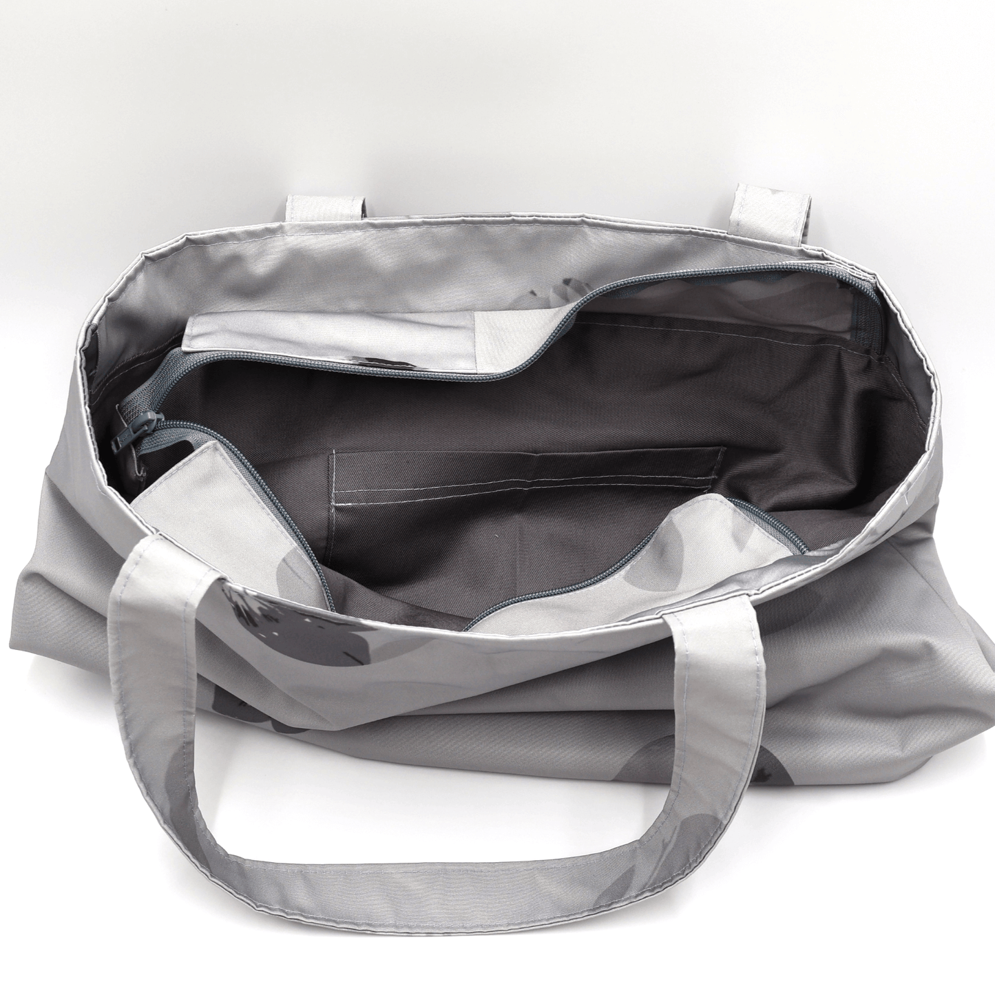 Secure top zip closure and internal pocket on a grey canvas shopper tote protecting books and everyday valuables.