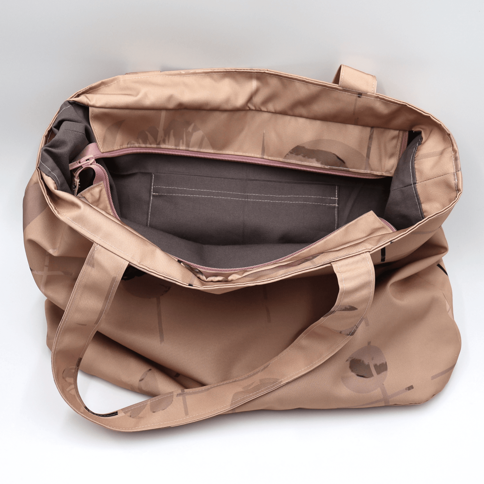 Secure top zip closure and internal pocket on a rusty orange canvas shopper tote protecting books and everyday valuables.