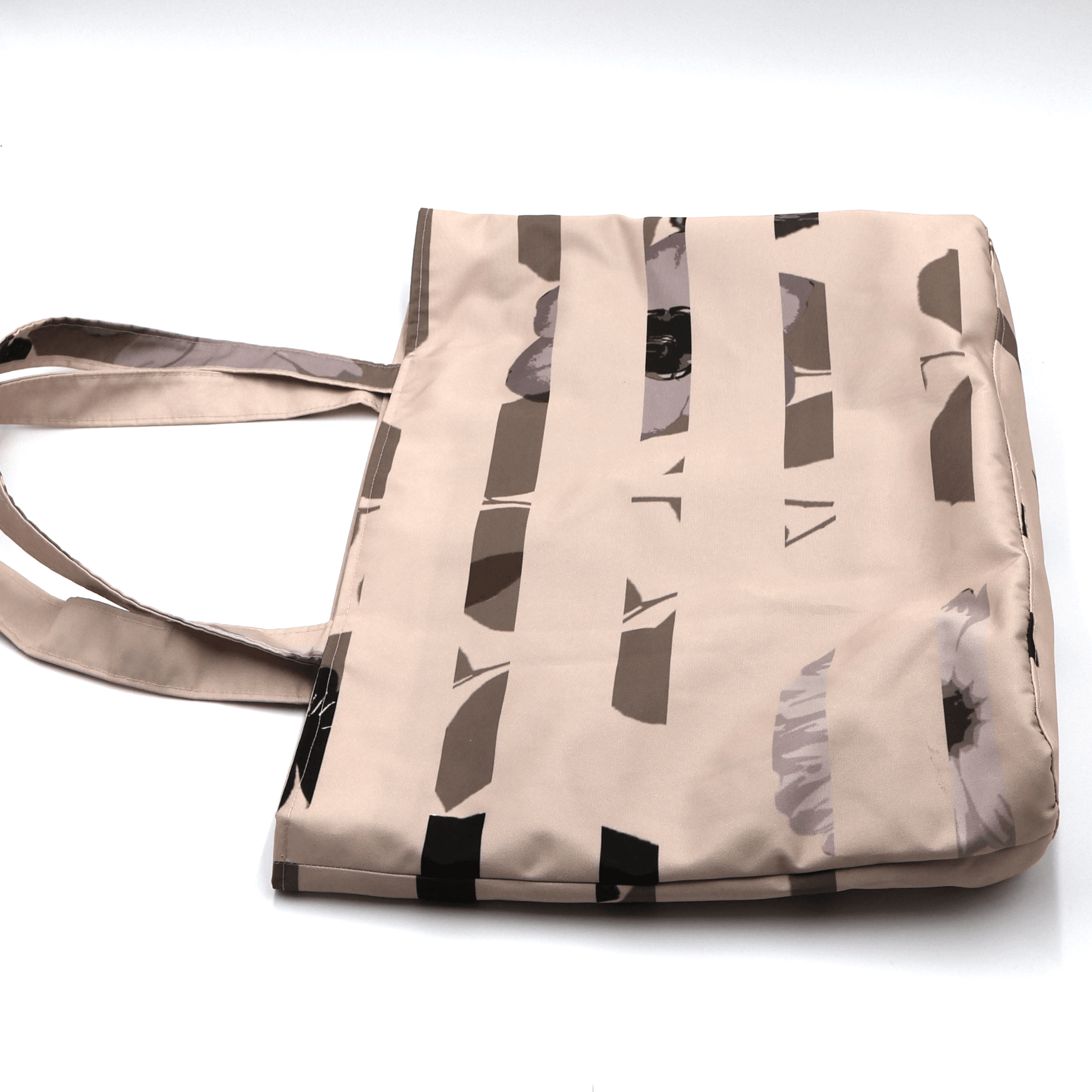 Close-up of the Ellie B Peach Moon Stripes print on a canvas tote bag, showcasing the soft dusty pink and rusty orange striped surface design with scattered petals.