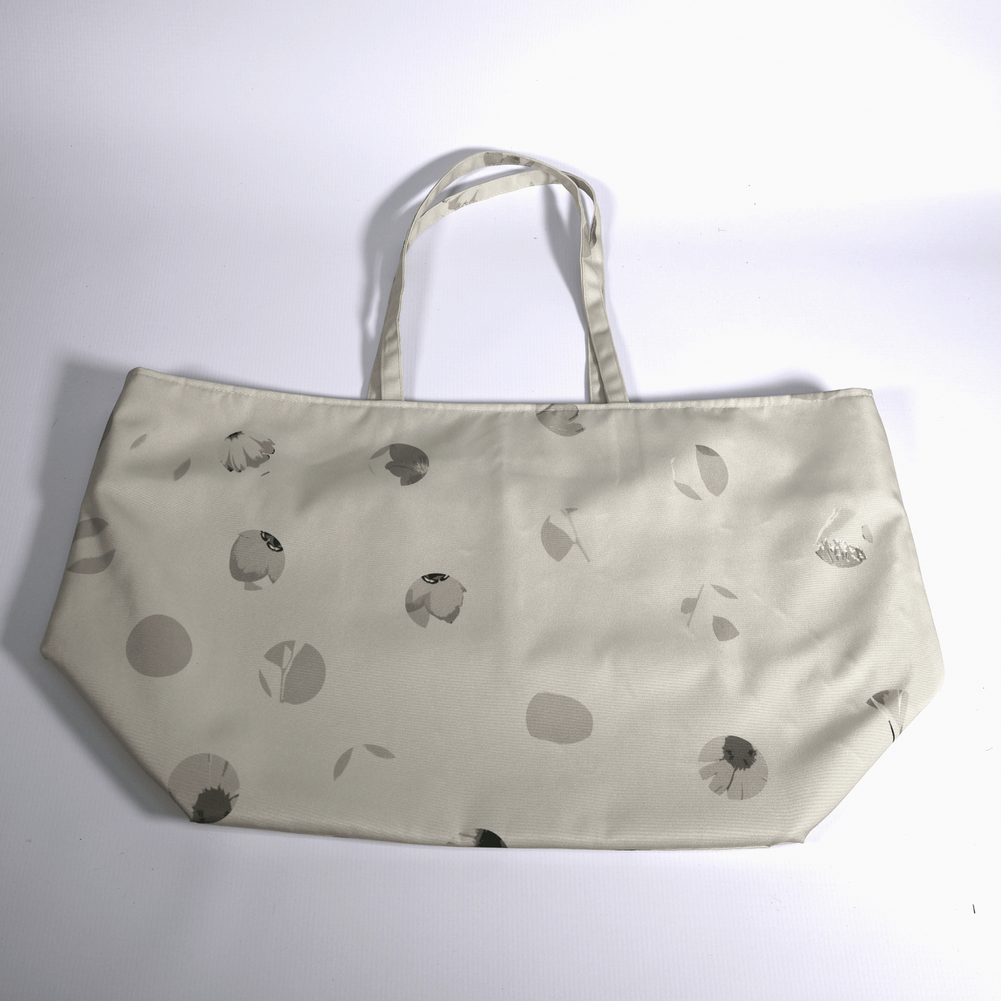 Close-up of the original Ellie B Moonrise surface print on a machine washable polyester canvas tote bag showing beige and cream scattered petals.