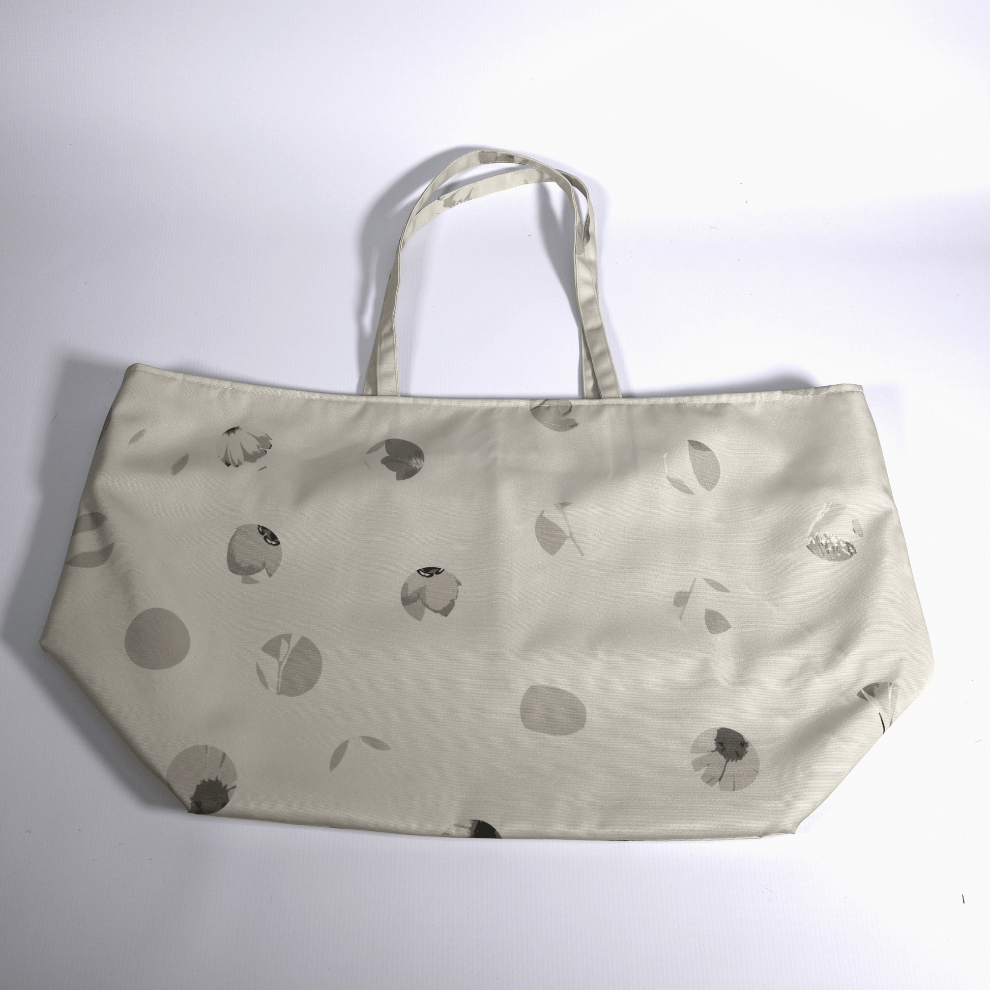 Close-up of the original Ellie B Moonrise surface print on a machine washable polyester canvas tote bag showing beige and cream scattered petals.