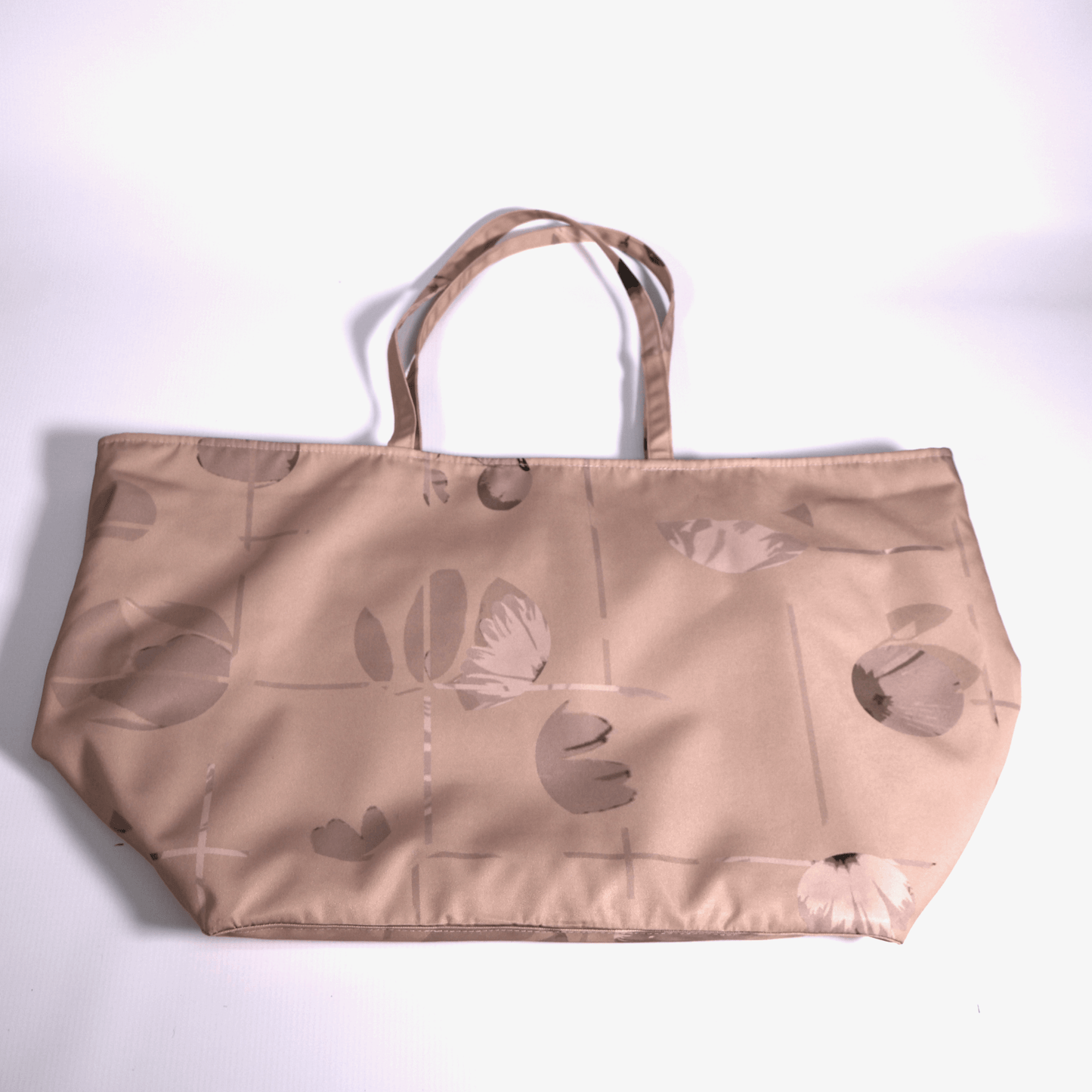Close-up of the original Ellie B Peach Moon surface print on a machine washable polyester canvas tote bag showing rusty orange and brown scattered petals.