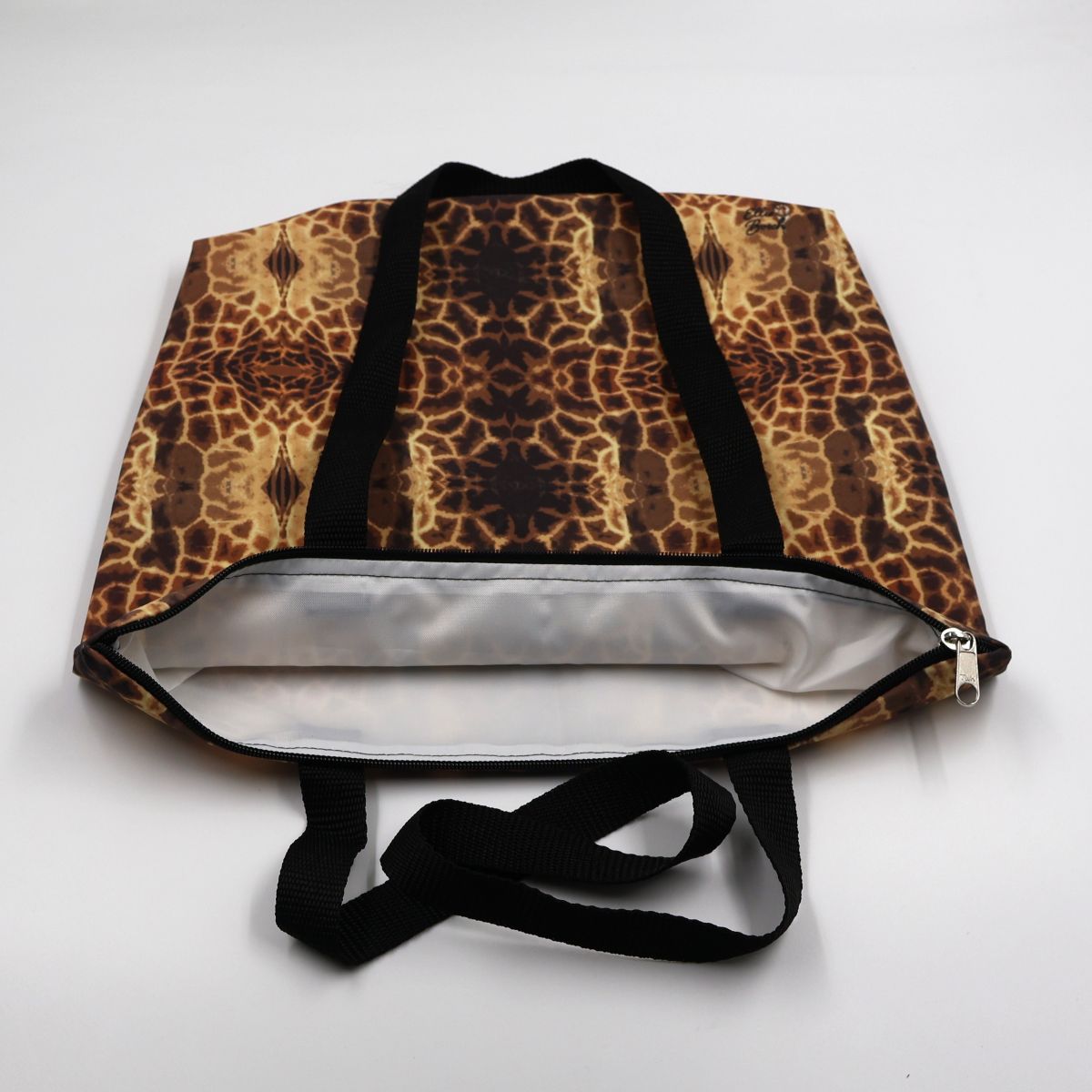 Close up view of the durable waterproof lining and premium stitching on charcoal giraffe canvas bag