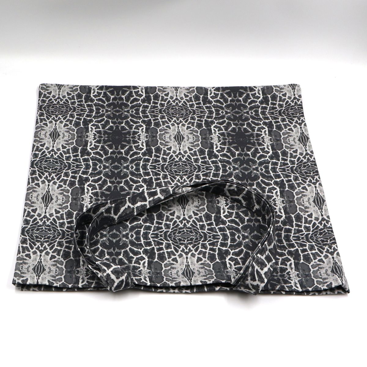 Flat lay view of Letheba modern charcoal grey giraffe spot canvas tote bag showing print design