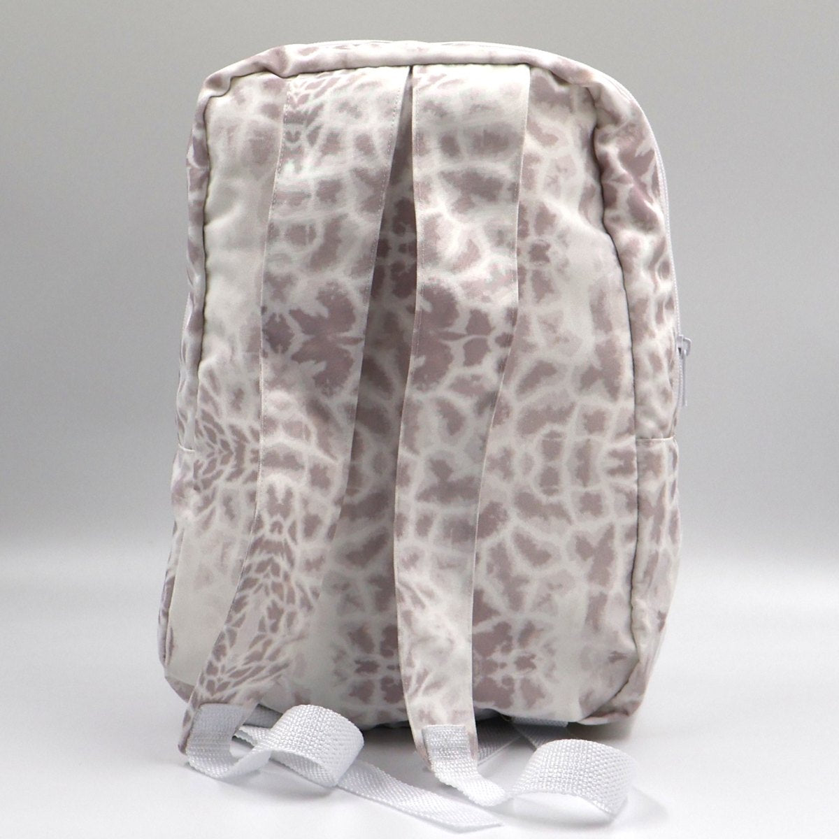 Back view of Letheba compact giraffe print canvas backpack showing comfortable adjustable shoulder straps