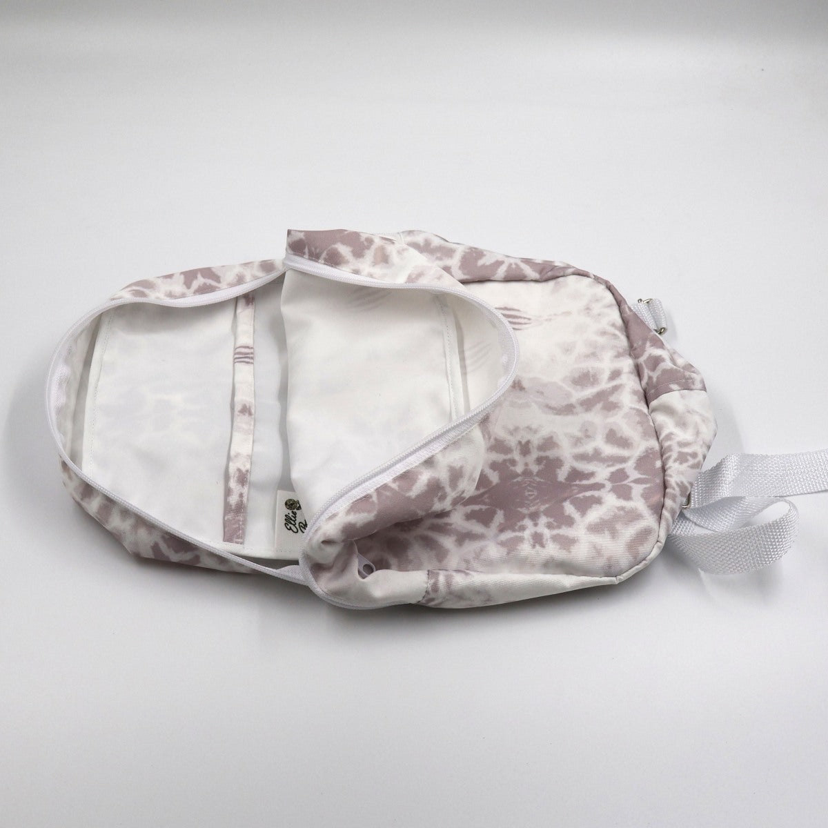 Flat lay view of Letheba mini polyester canvas backpack showing secure outside pocket and interior finishes