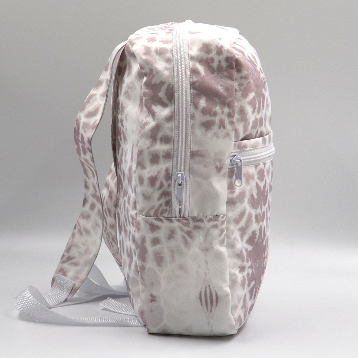Backpack with a patterned design on a gray background