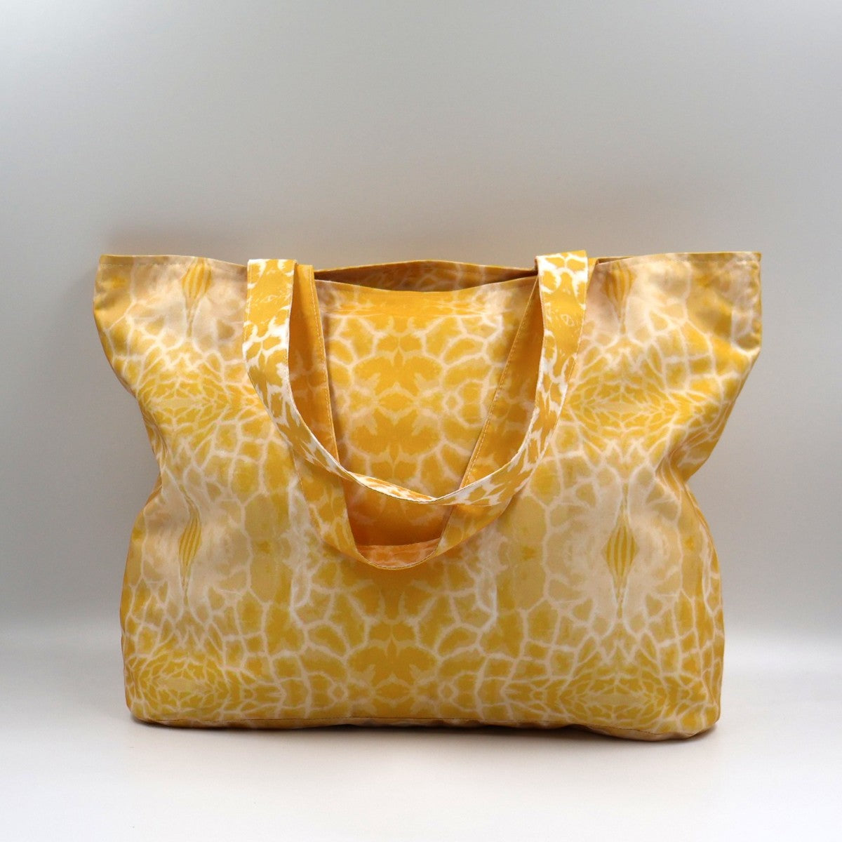 Front close up of Letheba sun yellow zipped giraffe print polyester canvas tote bag made in South Africa