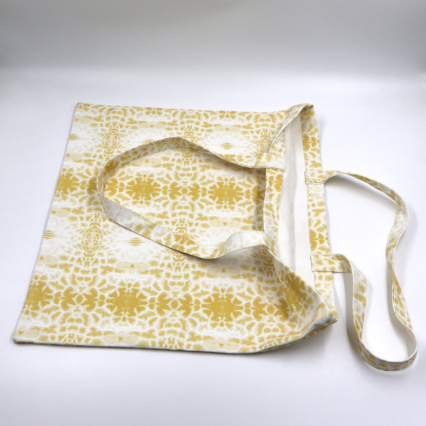 Close up view of quality stitching and finishes on butter yellow canvas giraffe print bag