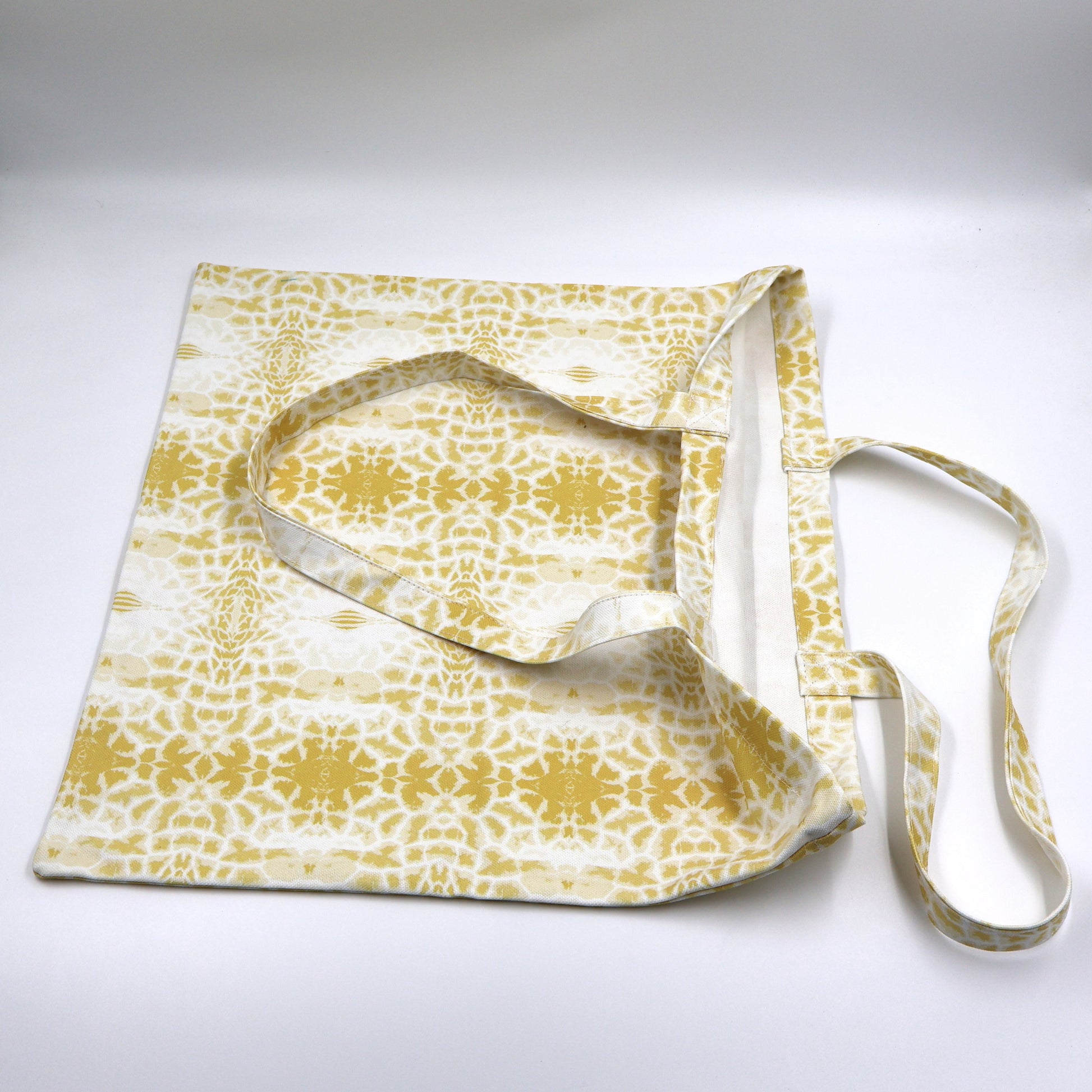 Close up view of quality stitching and finishes on butter yellow canvas giraffe print bag