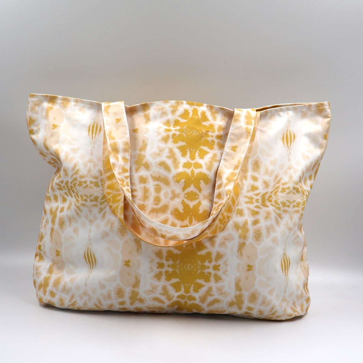 Front close up of Letheba yellow zipped giraffe print polyester canvas tote bag made in South Africa