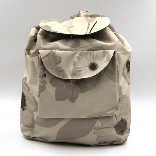 Lightweight foldable canvas backpack for travel in South Africa featuring the Ellie B Moonrise beige and cream scattered petals design.