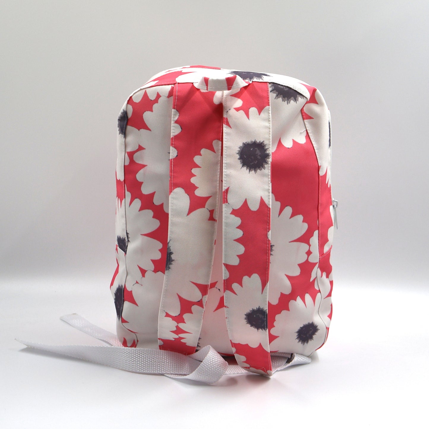 Back view of a small Pink Darling nature-inspired daypack showing the wide adjustable shoulder straps and durable seam stitching.