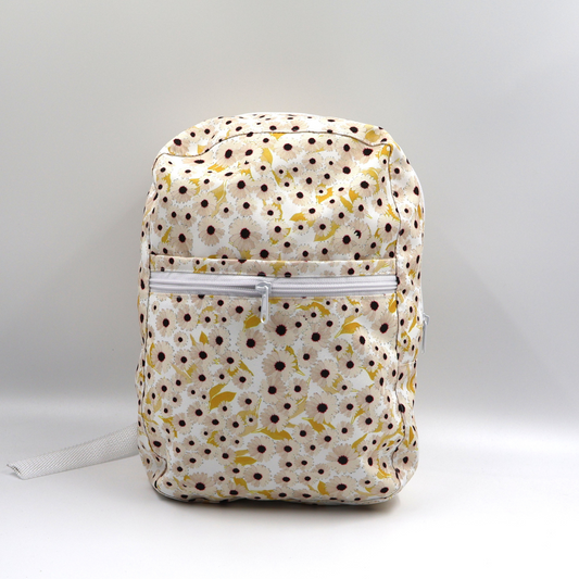 Front view of a small white water-resistant polyester canvas backpack highlighting the secure zippered front pocket.