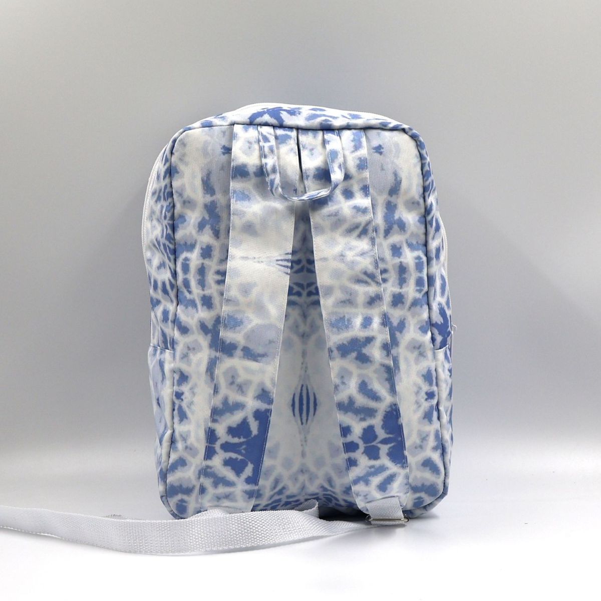 Back view of a small Blue Letheba nature-inspired daypack showing the wide adjustable shoulder straps and durable seam stitching