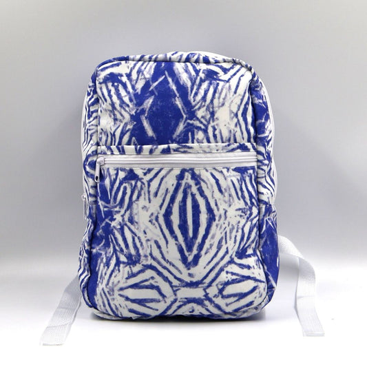 Front view of a small blue water-resistant polyester canvas backpack highlighting the zebra print pattern and secure zippered front pocket.
