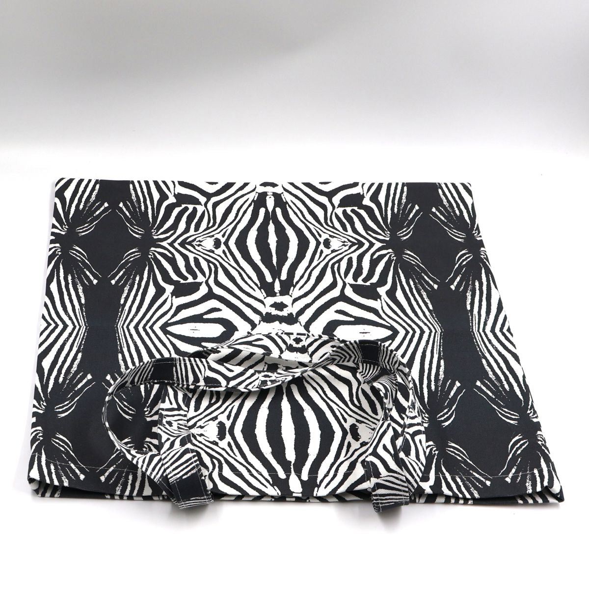 Flat lay view of Tshikwana classic zebra print canvas tote bag showing bold graphic layout