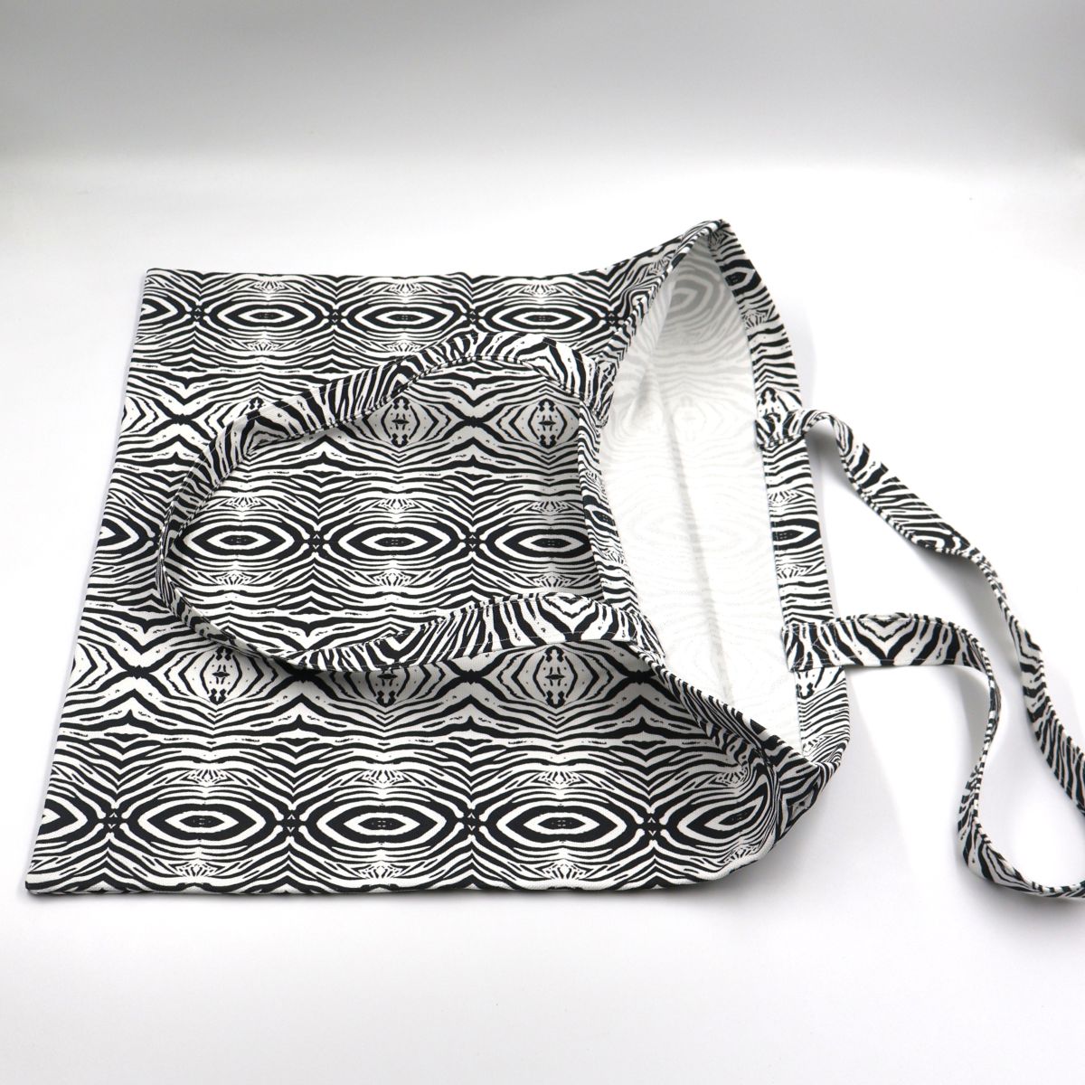 Close up view of quality stitching and finishes on black and white zebra canvas tote bag
