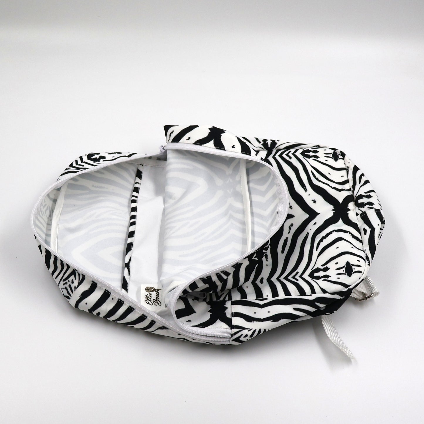 Flat lay view of Tshikwana monochrome zebra backpack showing secure outside zipped pocket