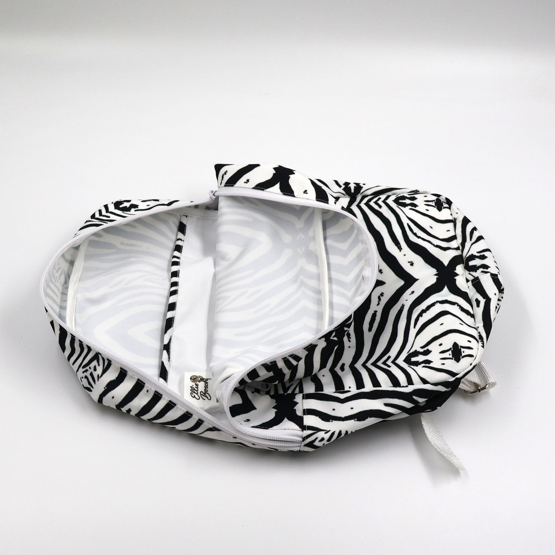 Flat lay view of Tshikwana monochrome zebra backpack showing secure outside zipped pocket