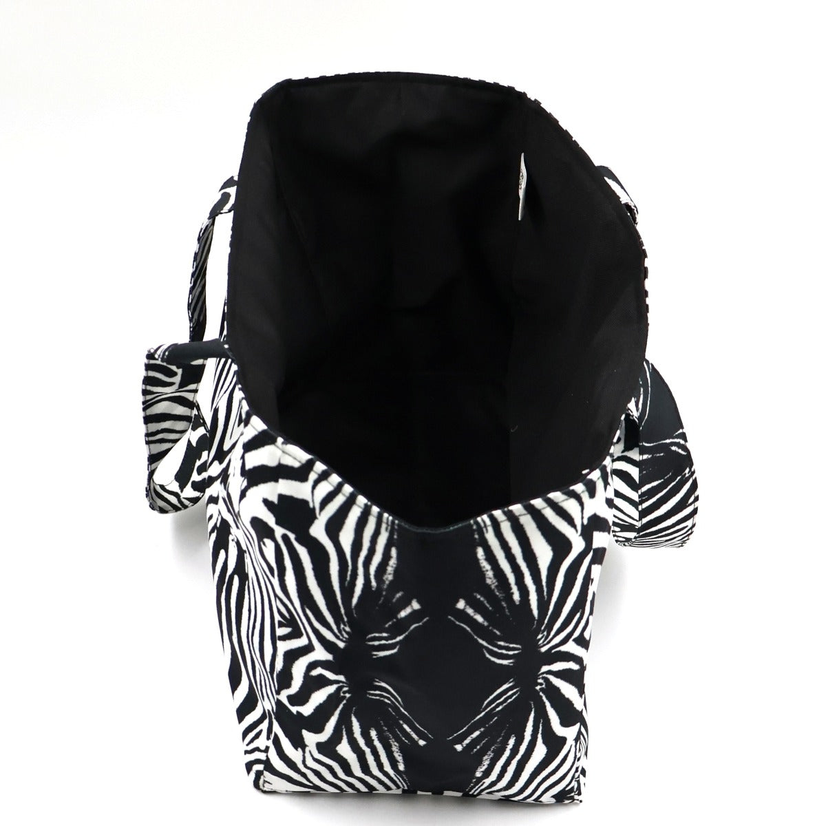 Side and wide base view of Tshikwana zebra stripe polyester canvas craft tote showing spacious interior