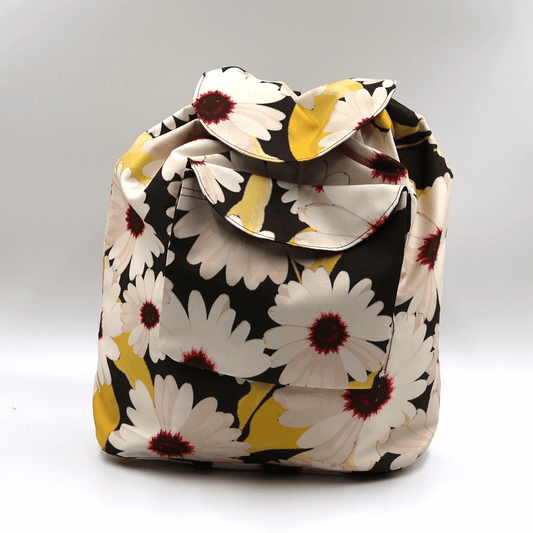 Lightweight backpack with drawstring and white daisy floral design on black background.